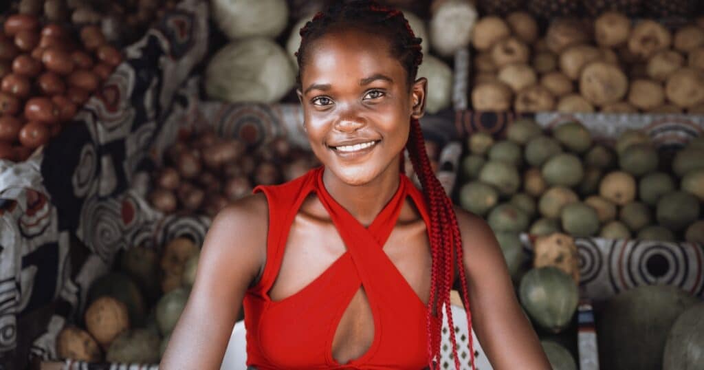 A young fruit seller smiling in Douala streets, Cameroon.