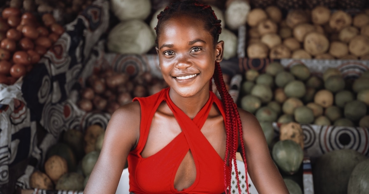 A young fruit seller smiling in Douala streets, Cameroon.
